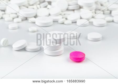 Bunch Of White Tablets. Scattered Pills. Single Pink Pill