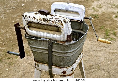 An old washing machine with two wringers and a galvanized tub.