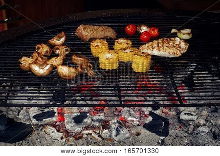 Vegetables And Meat Grilling.  Mushrooms Corn Pepper Tomatos Garlic On Grill. Catering In Food Court