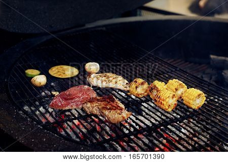 Vegetables And Meat Grilling.  Mushrooms Corn Pepper Tomatos Garlic On Grill. Catering In Food Court