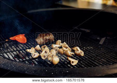 Vegetables And Meat Grilling.  Beefsteak Mushrooms  Tomatos Garlic On Grill. Catering In Food Court