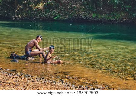 Goa, India - November 16, 2012: An unidentified Indian poor kids swimming playing and enjoying in water of Mandovi River in Goa, India. Road to the Dudhsagar Waterfall.