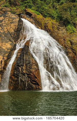 Falling water of the bottom of falls Dudhsagar Waterfall in the tropical jungle of India.
