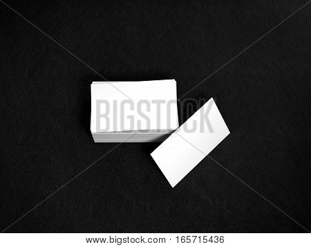Stack of white business cards. Name cards mockup template on black leather background. 3D Rendering with shadow