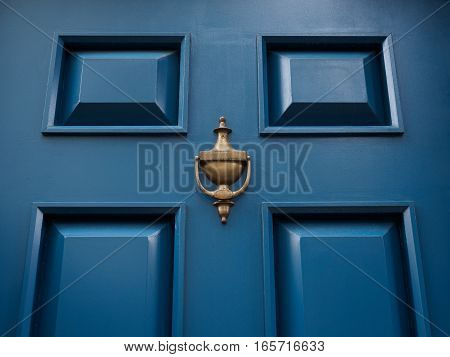 Blue modern classic door with bronze or metal knocker