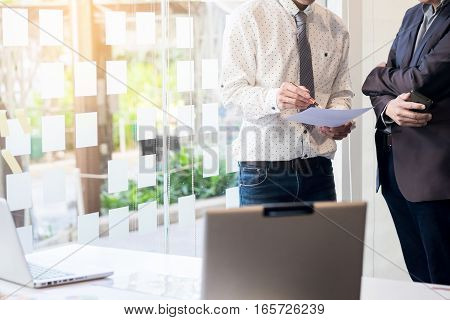 Teamwork process. young business managers crew working with new startup project. labtop on office wood table typing keyboard texting message analyze graph plans