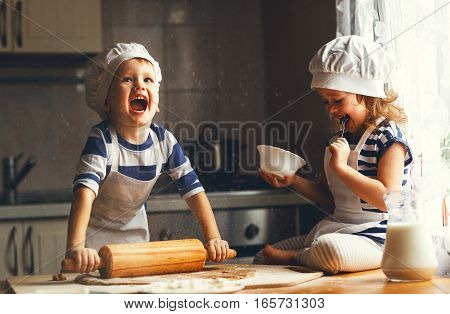 happy family funny kids are preparing the dough bake cookies in the kitchen