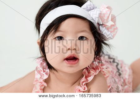 baby girl with cute floral dress and white background
