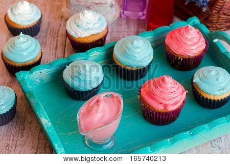 Homemade vanilla cupcakes with raspberry and mint cream