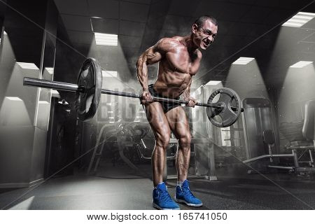 Muscular Man Doing Heavy Deadlift Exercise in gym