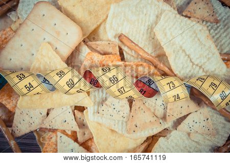 Vintage Photo, Centimeter With Salted Crisps, Cookies And Breadsticks, Unhealthy Food And Slimming