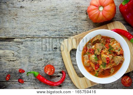 Traditional hungarian paprikash - chicken pork or beef goulash stew with paprika tomatoes garlic chilli and sour cream top view