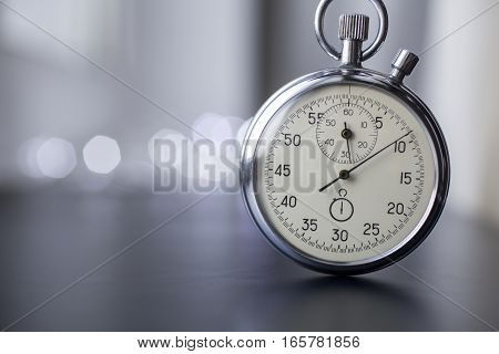 Clock on a blurry background. Stopwatch in work.