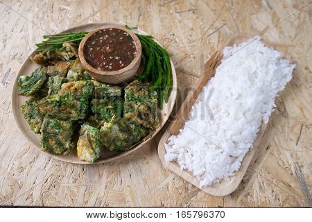 Cha om egg and rice on wood tray ready to eat