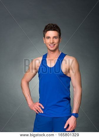 Handsome man on black background, blue t-shirt