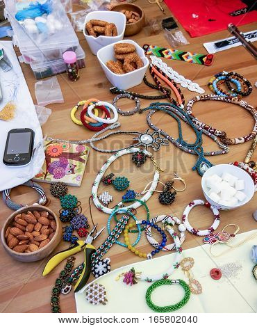 The process of creating jewelry with wire, beads and crystals. Working tools on the table. Handmade jewelry