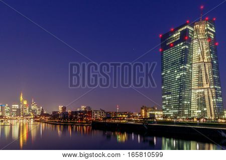 Picturesque views of the city's waterfront and skyscrapers at night in Frankfurt. Germany.