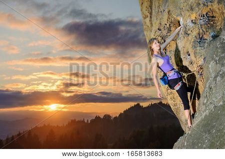 Female Climber Climbing With Rope On A Rocky Wall