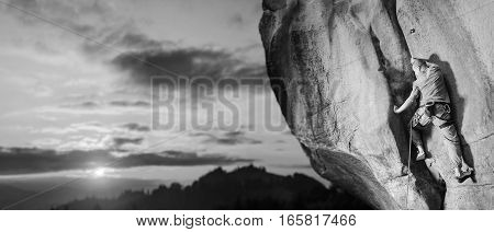Male Climber Climbing Big Boulder In Nature With Rope