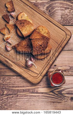 Bread crumbs spices and garlic on the wooden background.