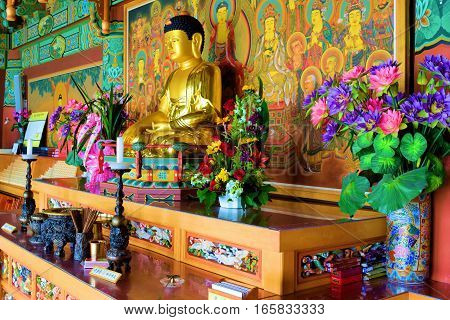 January 12, 2017 in Tehachapi, CA:  Buddha statue surrounded with colorful objects and decorations on an altar taken inside the Tae Go Sah Buddhist Monastery where visitors can mediate daily and attend Sunday Services in Tehachapi, CA