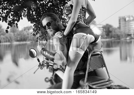 Portrait Of Brutal Biker And Beautiful Sexy Woman On Motorcycle