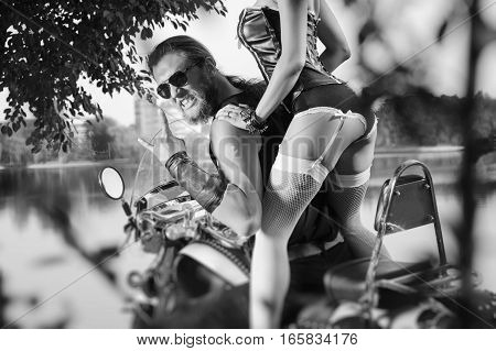 Portrait Of Brutal Biker And Beautiful Sexy Woman On Motorcycle