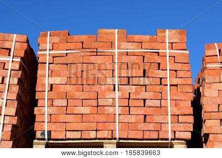 Red Bricks Stacked Into Cubes. Warehouse Bricks. Storage Brickworks Products