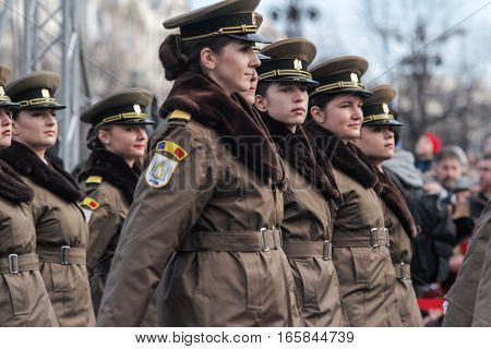 BUCHAREST ROMANIA DECEMBER 1 2015: Military women are marching for the National Day of Romania military parade in Bucharest. More than 3000 soldiers and personnel from security agencies take part in the massive parades on National Day of Romania.
