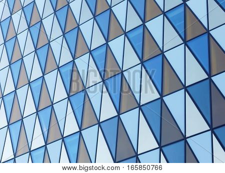 Colorful fasade made of triangles of different colors orange blue and white