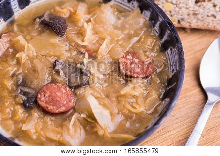 Christmas cabbage soup with mushrooms on natural background.
