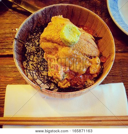 Japanese uni sashimi over rice and seaweed