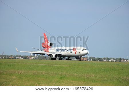 May11th 2015 Schiphol Airport the Netherlands: PH-MCU Martinair Holland McDonnell Douglas MD-11 on Polderbaan runway. Martin Air is based in Amsterdam and was founded in 1958 Since 2014 Martinair operates primarily as a cargo airline.