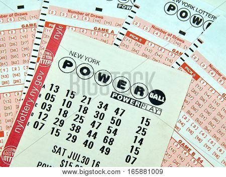 MONTREAL CANADA - DECEMBER 23 2016 : Powerball New York lottery tickets. Powerball is an American lottery game offered by 44 states the District of Columbia Puerto Rico and the US Virgin Islands.