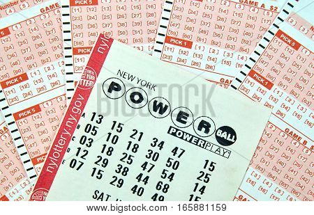 MONTREAL CANADA - DECEMBER 23 2016 : Powerball New York lottery tickets. Powerball is an American lottery game offered by 44 states the District of Columbia Puerto Rico and the US Virgin Islands.