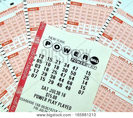 MONTREAL CANADA - DECEMBER 23 2016 : Powerball New York lottery tickets. Powerball is an American lottery game offered by 44 states the District of Columbia Puerto Rico and the US Virgin Islands.