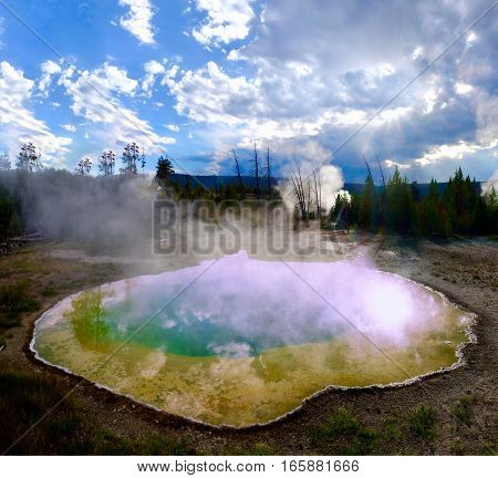 Steaming geyser Morning Glory Pool in the Upper Geyser Basin. Yellowstone National Park. Wyoming. United States.