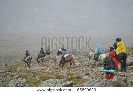 Aug 18 2012 - a Group of tourists on horseback go through the Sayan mountains. Equestrian expedition. Aug 18 2012.