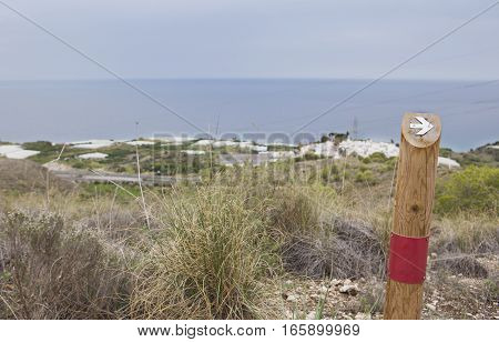 Hiking sign at trekking path over Nerja Caves Mountain. Overlooking Town of Nerja Malaga Spain