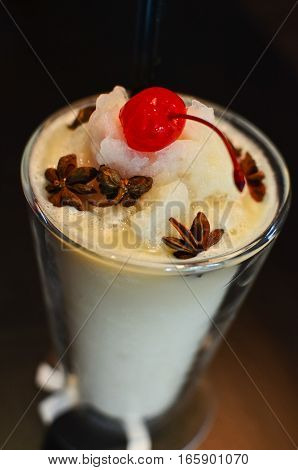 Closeup lychee smoothie with cherry and cinamon decoration