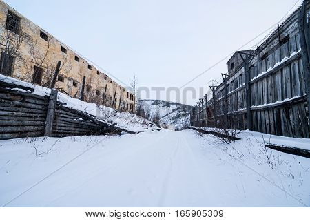 Exterior of buildings of old decayed abandoned prison in Kolyma