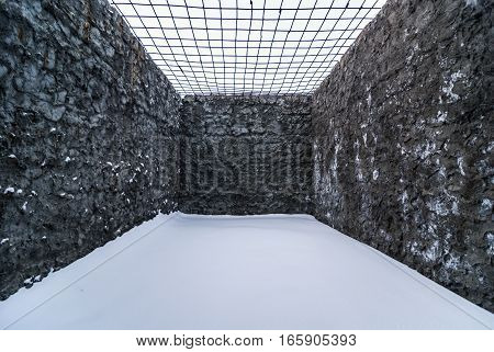 Interior of opened cell for walking in old abandoned prison in Kolyma