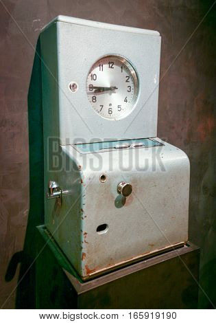 An old time clock for employees to keep track of their working hours.