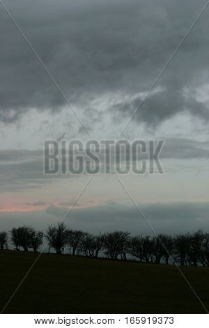 Storm clouds and a dusky sky over a silhouetted horizon, Wales, UK.