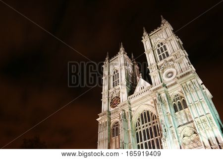 Westminster Abbey, London, UK.  Low angle night view of the façade to the iconic London landmark cathedral at Westminster.