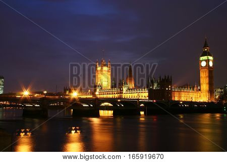 The Houses of Parliament, London, UK. View of the iconic London landmark over the River Thames at night.
