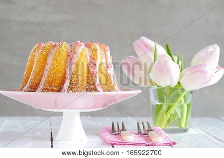 homemade bundt cake with sugar glaze and sugar sprinkles