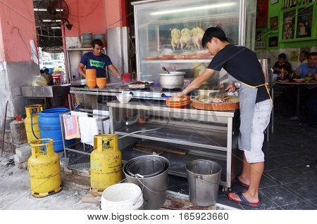 Unidentified Vendor Prepares Steam Chicken On His Stall