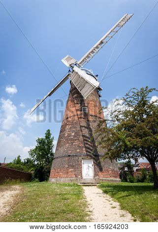 CAMBRIDGESHIRE UK - JUNE 8 2006: A traditional old English windmill which used to be a common sight on the flat Cambridgeshire Fenland.
