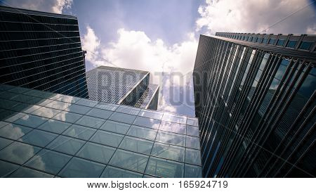 A low angle view of the glass and steel skyscrapers in London's Docklands district a key UK financial and business district.